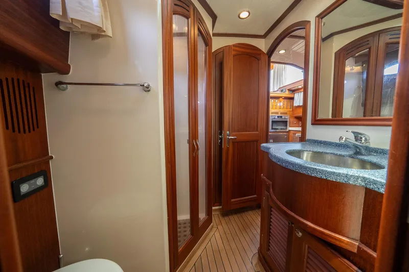 Dreadnought Yacht Photos Pics Luxurious 2007 Vicem 65 yacht bathroom with wooden cabinetry and modern fixtures.