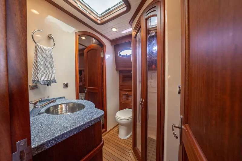Dreadnought Yacht Photos Pics Luxurious 2007 Vicem 65 yacht bathroom with wood accents and modern fixtures.