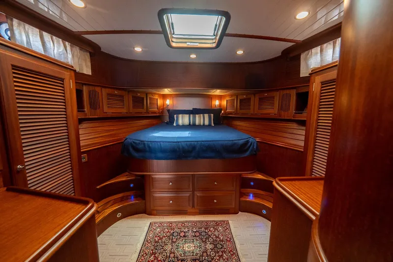 Dreadnought Yacht Photos Pics Luxurious 2007 Vicem 65 yacht cabin with elegant wood finish and cozy bedding.