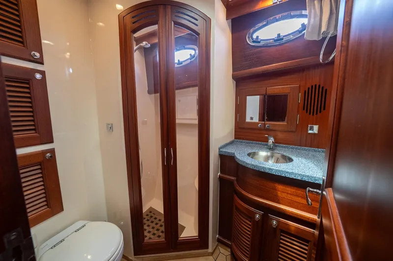 Dreadnought Yacht Photos Pics Luxurious 2007 Vicem 65 yacht bathroom with wooden cabinetry and modern fixtures.