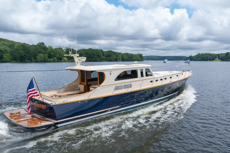 Dreadnought Yacht Photos Pics 2007 Vicem 65 yacht cruising on a scenic river under cloudy skies.