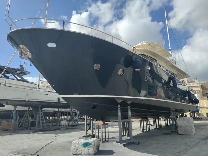  Yacht Photos Pics 2013 Apreamare Maestro 65 yacht on dry dock under a cloudy sky.
