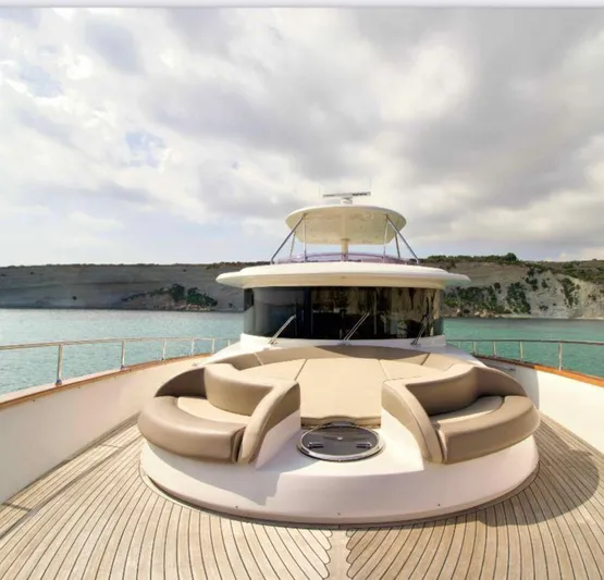  Yacht Photos Pics Luxurious 2013 Apreamare Maestro 65 yacht with elegant deck seating and scenic coastal backdrop.