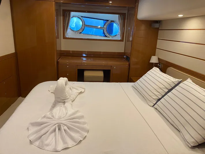  Yacht Photos Pics Luxurious cabin interior of 2013 Apreamare Maestro 65 yacht with elegant bedding and porthole view.