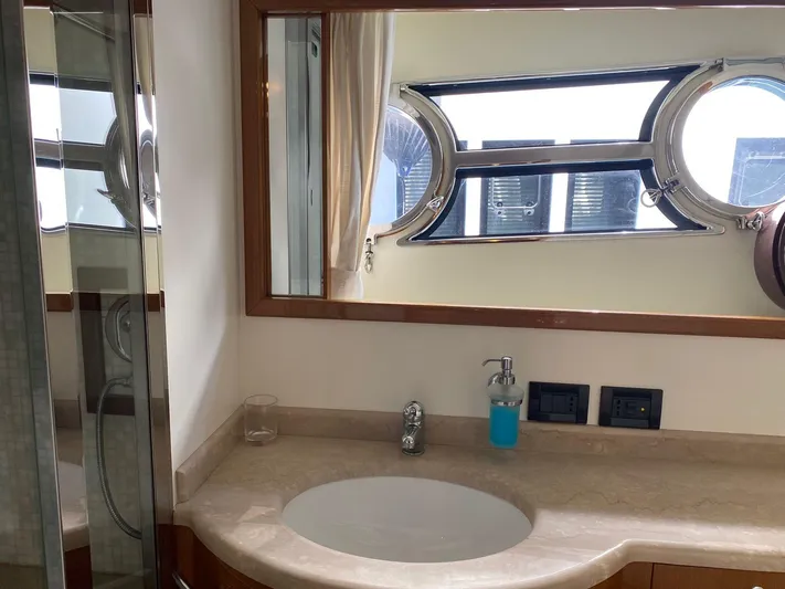  Yacht Photos Pics Luxurious bathroom on 2013 Apreamare Maestro 65 yacht with elegant fixtures and porthole window.