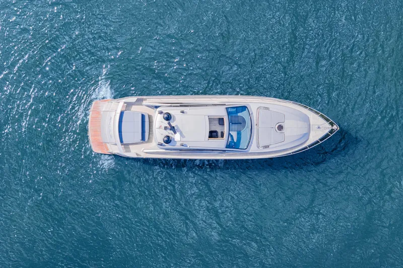  Yacht Photos Pics Aerial view of 2016 Pershing 62' yacht cruising on blue ocean waters.