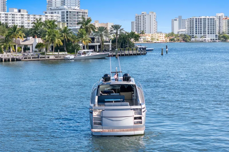  Yacht Photos Pics Luxury 2016 Pershing 62' yacht cruising near waterfront cityscape.