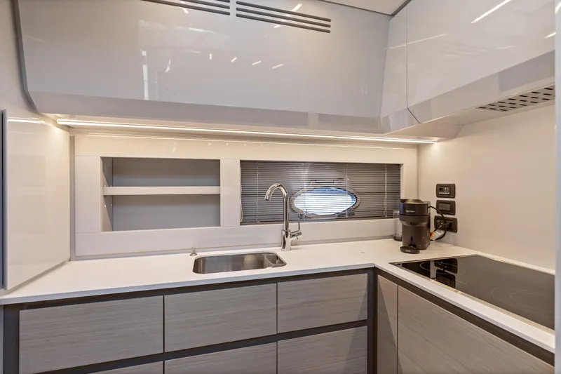  Yacht Photos Pics Modern kitchen interior of 2016 Pershing 62' yacht with sleek design and appliances.