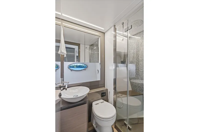  Yacht Photos Pics Luxurious bathroom on 2016 Pershing 62' yacht with modern fixtures and glass shower.