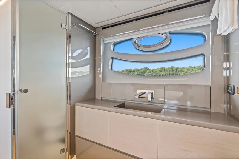  Yacht Photos Pics Luxurious bathroom interior of 2016 Pershing 62' yacht with modern fixtures and scenic window view.
