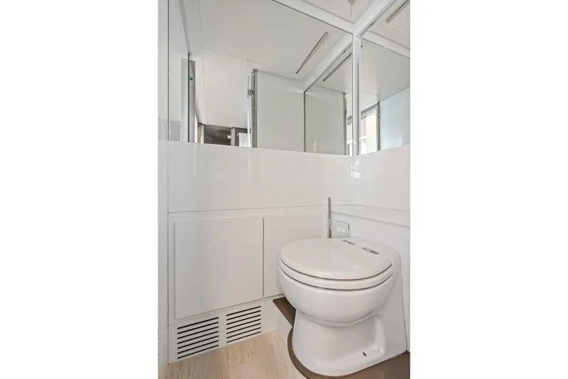  Yacht Photos Pics Modern bathroom on 2016 Pershing 62' yacht with sleek white design.