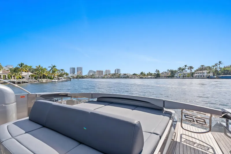  Yacht Photos Pics 2016 Pershing 62' yacht deck with waterfront view, palm trees, and clear blue sky.