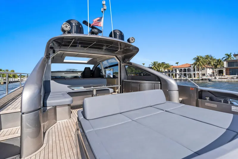  Yacht Photos Pics 2016 Pershing 62' yacht with spacious deck, luxurious seating, and waterfront view.