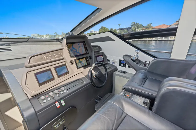  Yacht Photos Pics Cockpit of 2016 Pershing 62' yacht with advanced navigation systems and leather seating.