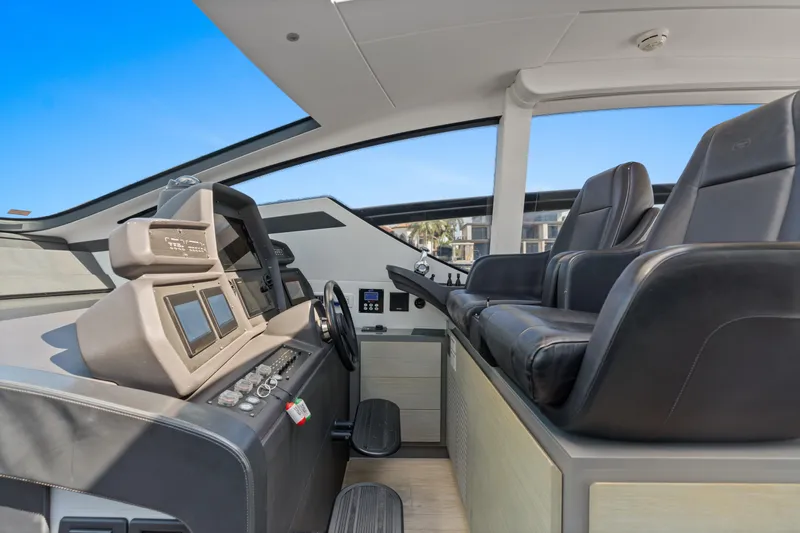  Yacht Photos Pics Interior helm of 2016 Pershing 62' yacht with modern controls and leather seating.