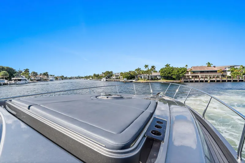  Yacht Photos Pics 2016 Pershing 62' yacht cruising on a scenic waterway with waterfront homes.