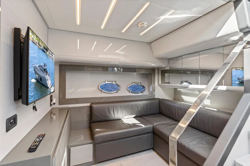  Yacht Photos Pics Luxurious interior of 2016 Pershing 62' yacht with modern seating and TV.