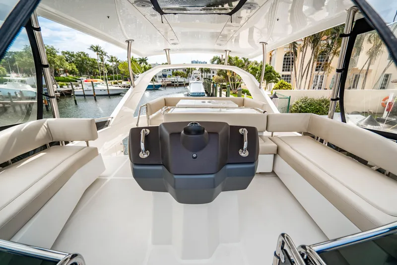 Altair Yacht Photos Pics 2019 Aquila 44 Yacht interior with spacious seating and modern helm, docked in a marina.