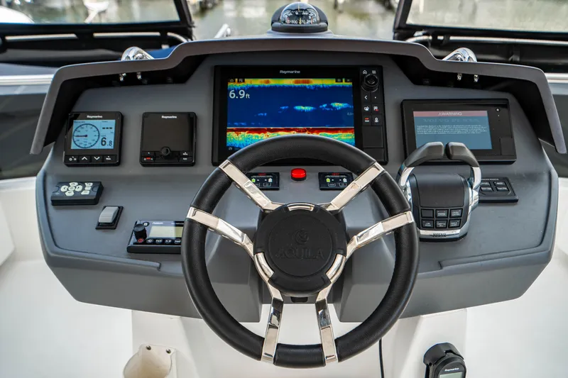Altair Yacht Photos Pics Steering console of 2019 Aquila 44 Yacht with advanced navigation displays and controls.