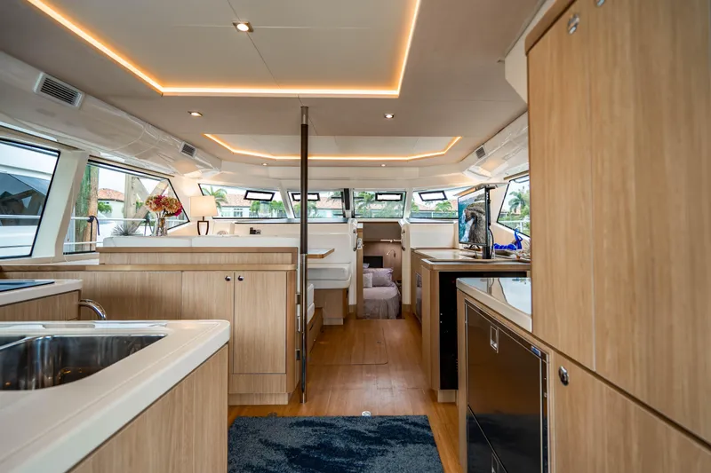 Altair Yacht Photos Pics Luxurious interior of 2019 Aquila 44 Yacht with modern wood finishes and ample natural light.