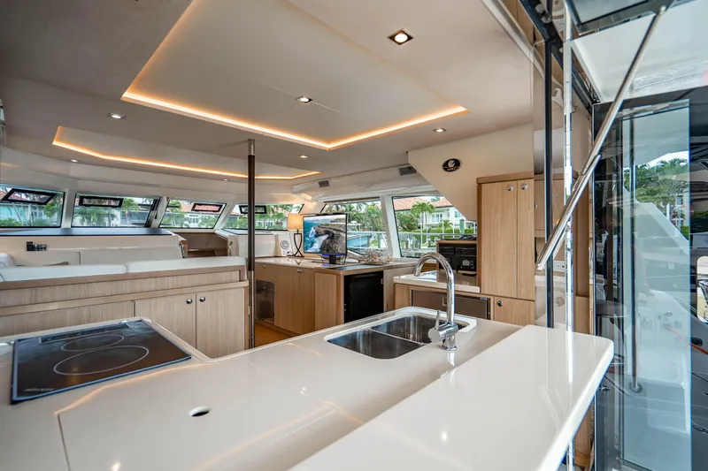 Altair Yacht Photos Pics Luxurious interior of 2019 Aquila 44 Yacht with modern kitchen and panoramic windows.