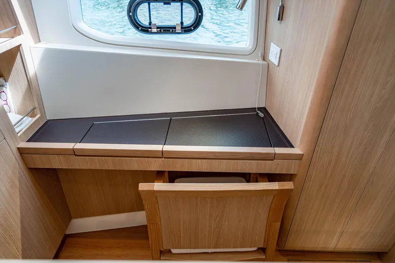 Altair Yacht Photos Pics Interior of 2019 Aquila 44 Yacht featuring a sleek wooden desk and chair.