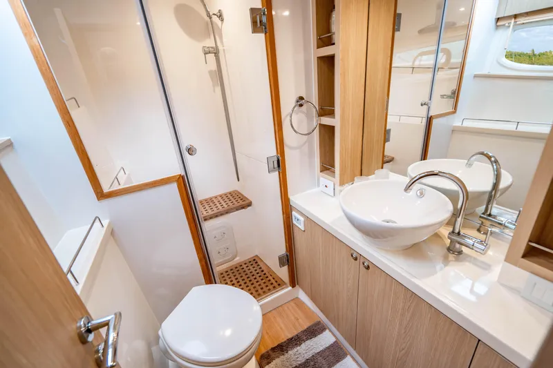 Altair Yacht Photos Pics Luxurious bathroom in 2019 Aquila 44 Yacht with modern fixtures and wooden accents.