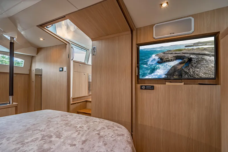 Altair Yacht Photos Pics Luxurious interior of 2019 Aquila 44 Yacht with wood paneling and flat-screen TV.