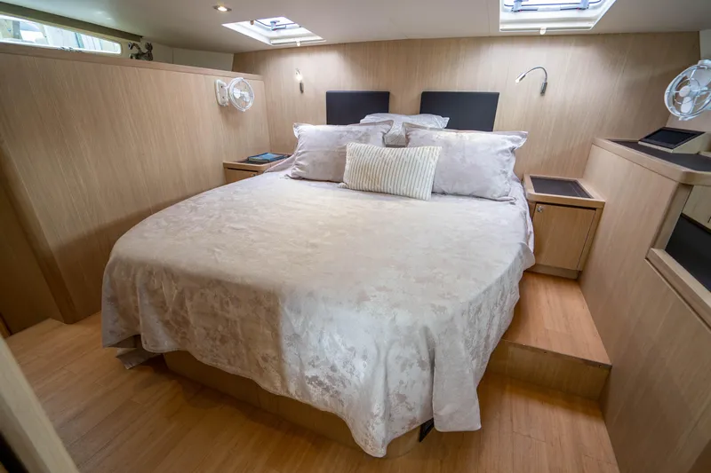 Altair Yacht Photos Pics Luxurious bedroom interior of 2019 Aquila 44 Yacht with elegant bedding and wood finish.
