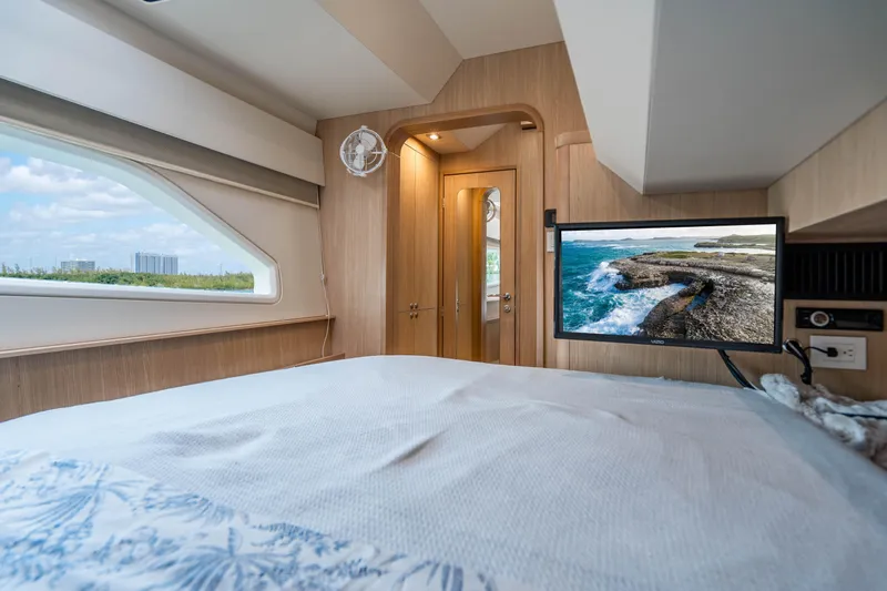 Altair Yacht Photos Pics Luxurious interior of 2019 Aquila 44 Yacht with scenic window view and mounted TV.