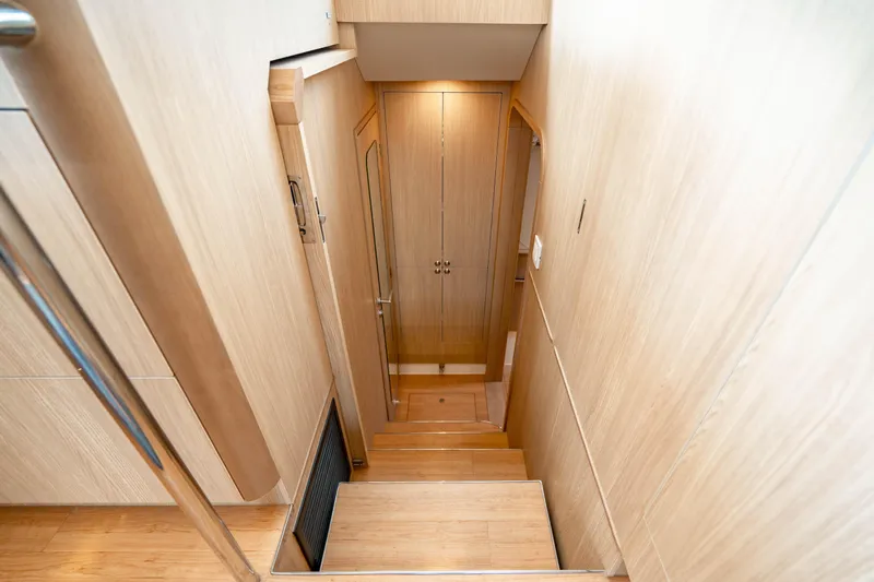 Altair Yacht Photos Pics Interior staircase of 2019 Aquila 44 Yacht with wooden finish and modern design.