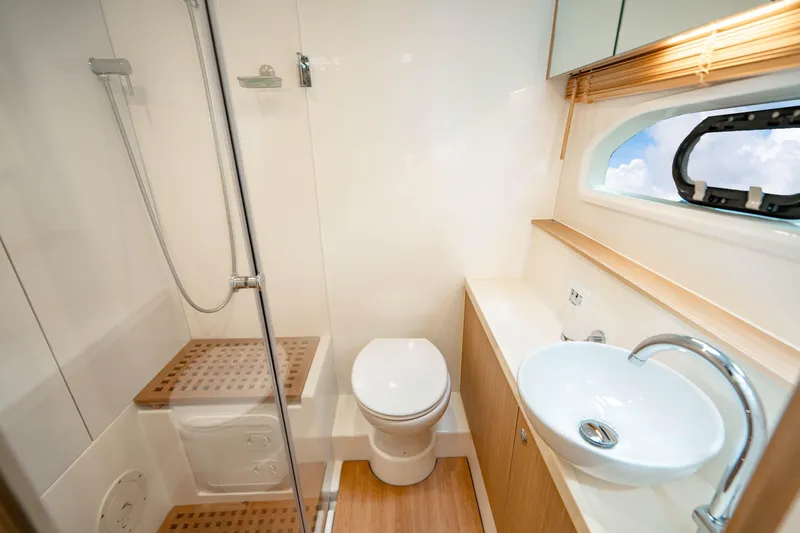 Altair Yacht Photos Pics Luxurious bathroom on 2019 Aquila 44 Yacht with shower, toilet, and sink.