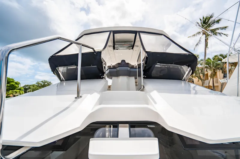 Altair Yacht Photos Pics 2019 Aquila 44 Yacht with sleek design, docked under a partly cloudy sky.