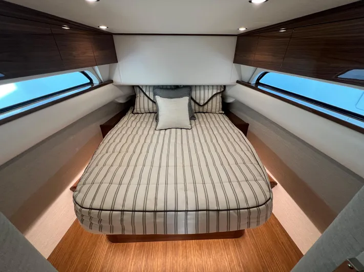 2026 Valhalla V-55 Yacht Photos Pics Luxurious cabin interior of 2025 Valhalla Boatworks V-55 with striped bedding.