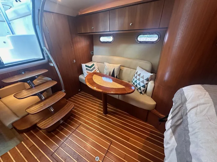 Five Too Soon Yacht Photos Pics 2008 Tiara Yachts 3500 Sovran interior with wooden flooring, cozy seating, and decorative pillows.