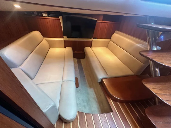 Five Too Soon Yacht Photos Pics Interior of 2008 Tiara Yachts 3500 Sovran with beige seating and wooden flooring.
