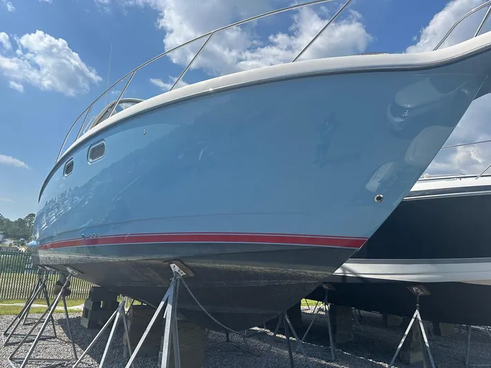 Five Too Soon Yacht Photos Pics 2008 Tiara Yachts 3500 Sovran on stands, blue hull, sunny day.