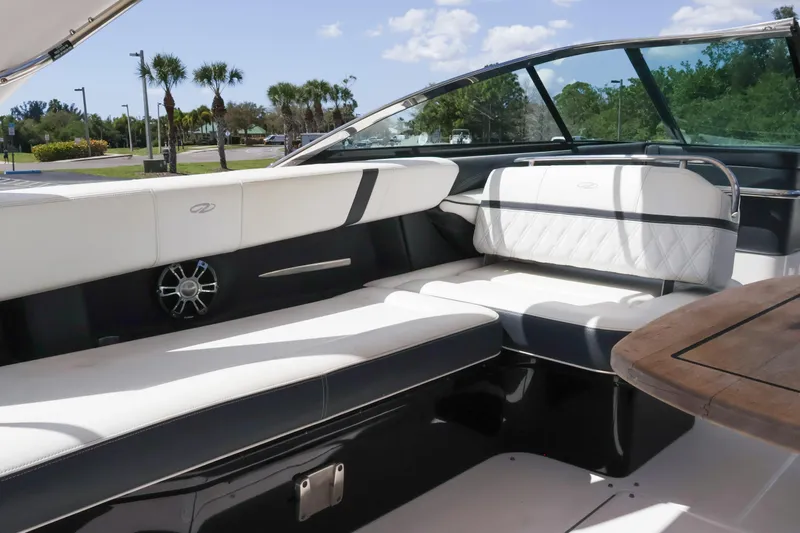  Yacht Photos Pics Luxurious interior of 2019 Regal 29 OBX boat with white seating and wooden table.