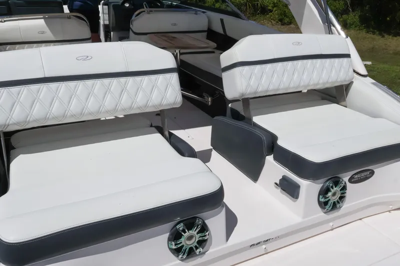  Yacht Photos Pics 2019 Regal 29 OBX boat interior with white cushioned seating and stylish design.