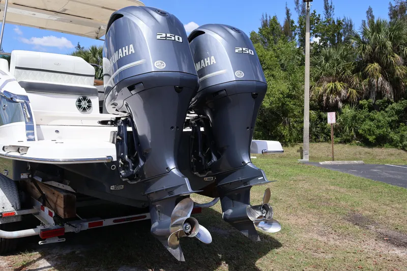  Yacht Photos Pics 2019 Regal 29 OBX boat with twin Yamaha 250 outboard engines, parked on a trailer.