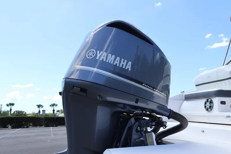  Yacht Photos Pics 2019 Regal 29 OBX with Yamaha four-stroke outboard motor in a parking lot.