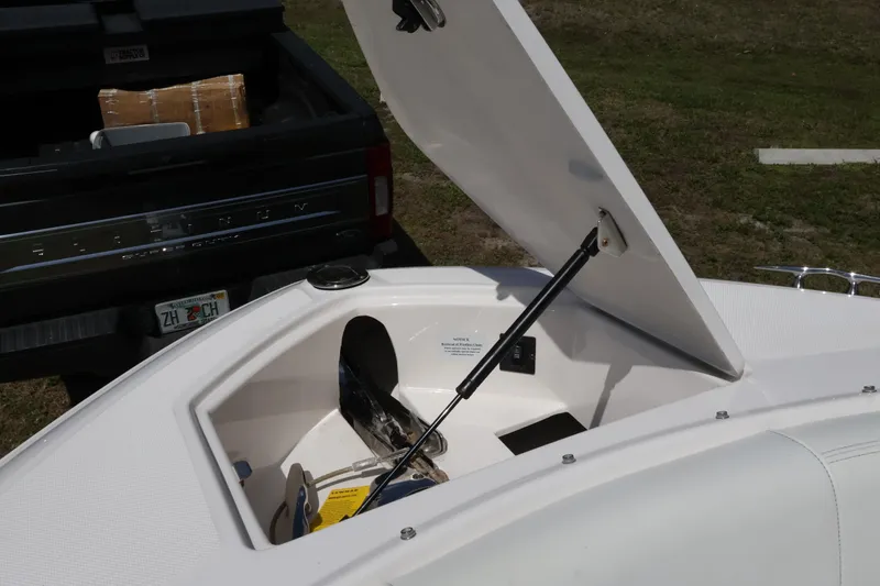  Yacht Photos Pics Open storage compartment on 2019 Regal 29 OBX boat, with truck in background.