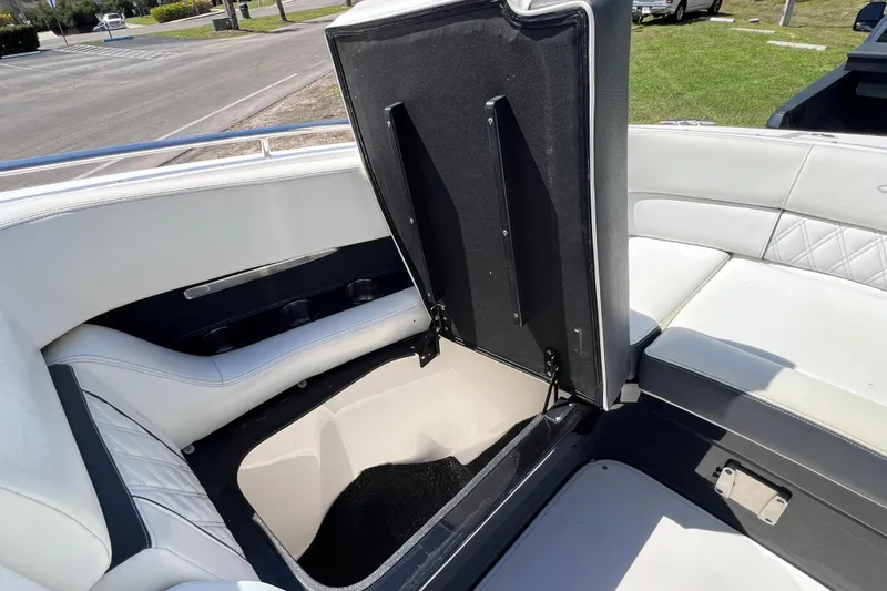  Yacht Photos Pics 2019 Regal 29 OBX boat interior with open storage compartment and white seating.