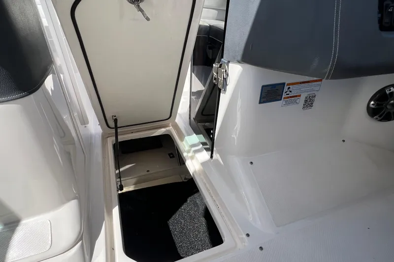  Yacht Photos Pics 2019 Regal 29 OBX boat interior storage compartment with open hatch.