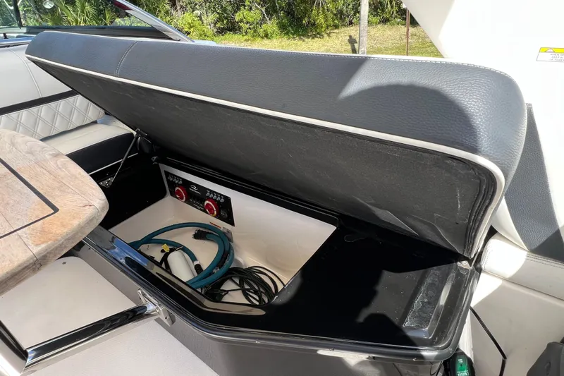  Yacht Photos Pics Open storage compartment in 2019 Regal 29 OBX boat, showing cables and equipment.