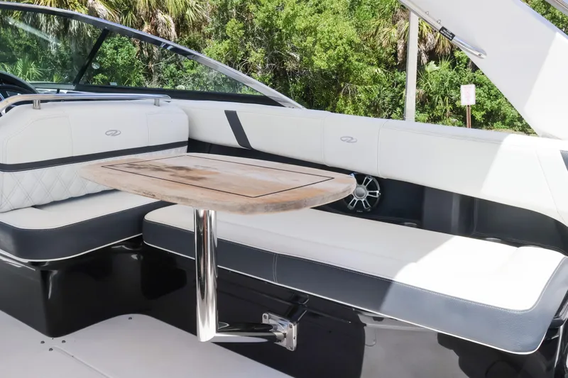  Yacht Photos Pics 2019 Regal 29 OBX boat interior with white seating and wooden table.