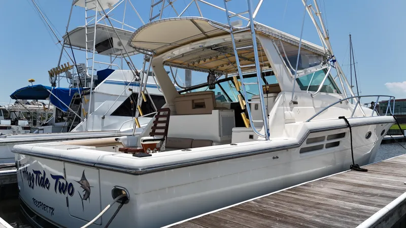Hoggtide Two Yacht Photos Pics 1998 Tiara Yachts 4100 Open docked at a marina on a sunny day.