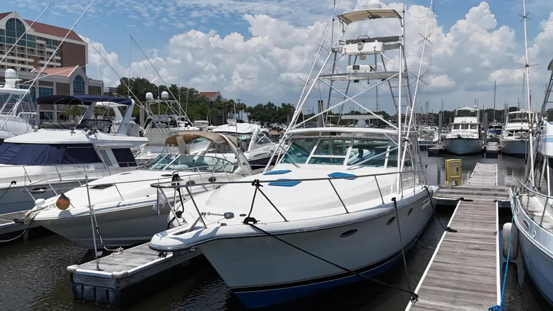 Hoggtide Two Yacht Photos Pics 1998 Tiara Yachts 4100 Open docked at a marina on a sunny day.