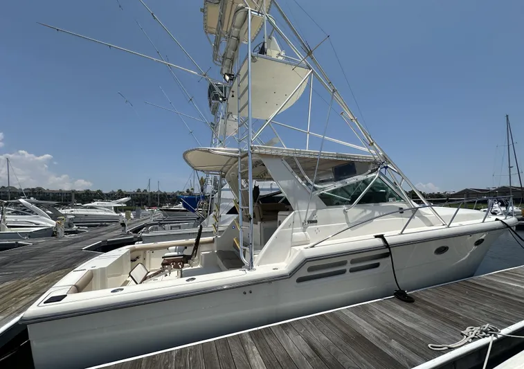Hoggtide Two Yacht Photos Pics 1998 Tiara Yachts 4100 Open docked at a marina on a sunny day.