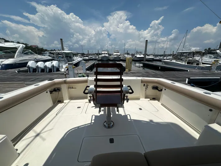 Hoggtide Two Yacht Photos Pics 1998 Tiara Yachts 4100 Open at marina, featuring spacious deck and captain's chair.